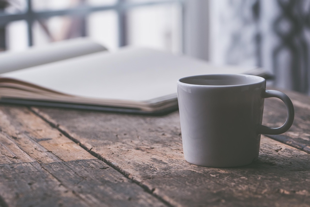 Coffee and journal on wooden table